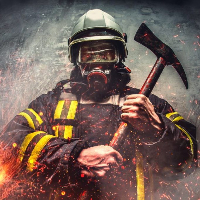 Rescue firefighter man in a fire holds iron axe.
